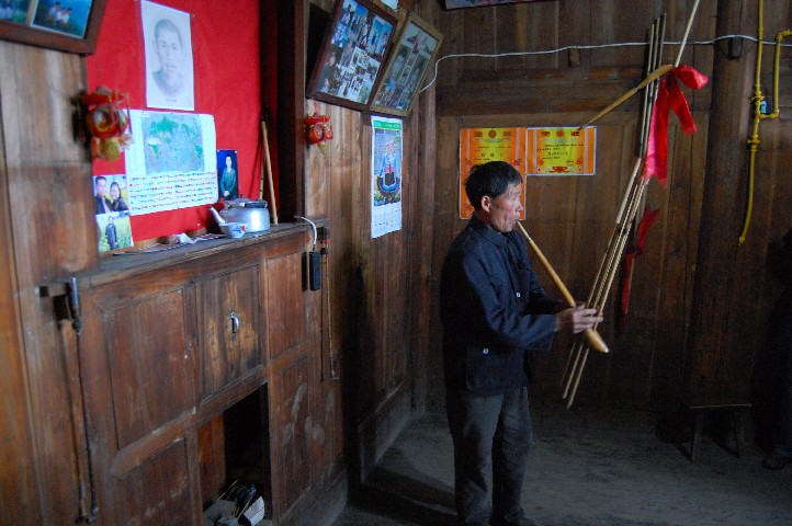 Playing the reed pipe in their living room