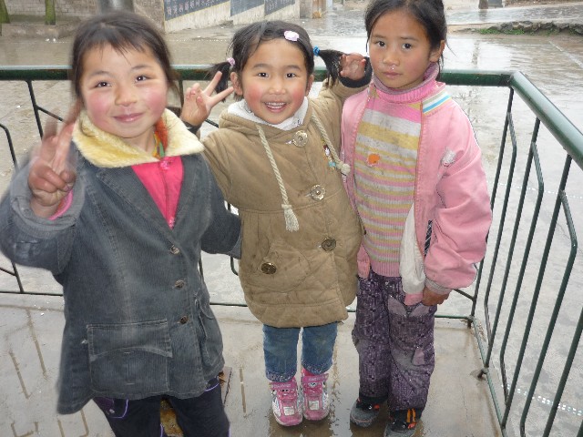 School children making typical photo guestures