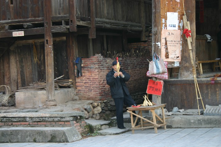 Man selling reed pipes