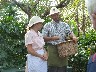 Showing us the basket used to collect and measure the coffee cherries