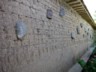 Mud wall with engraved faces