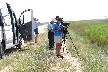 Men in sun with telescopes